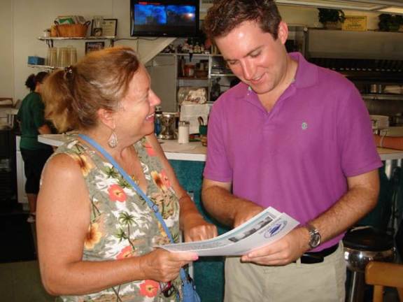 Skoufis: Legoland tax breaks ‘far too generous’ Robin Boroden of Goshen stops in at Elsie's Luncheonette on Main Street, Goshen, to discuss local issues with Assemblyman James Skoufis, who was there on Aug. 16 as one of his "Skoufis on Your Street" visits. (Photo by Geri Corey)