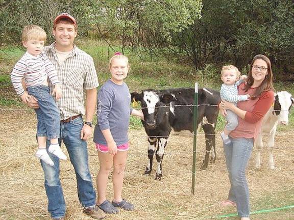 The Touw family at Wagon Wheel Farm (from left): Jason Touw, holding his son, Owen, 4; daughter Baylie, 12; and Kristin, holding son, Emmett, 16-months old.