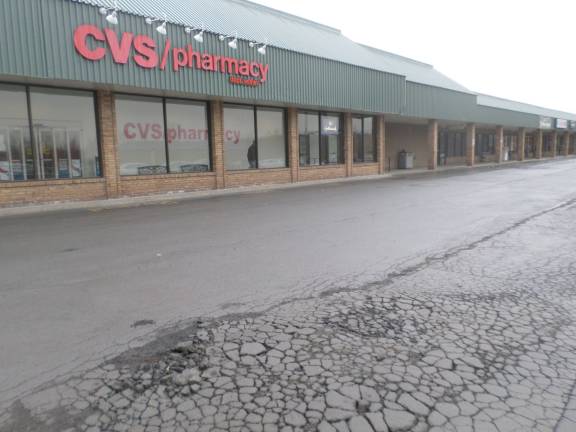 The CVS Pharmacy anchors the Goshen Center Plaza, which will be the subject of a bankruptcy auction on April 15. Cracks in the pavement of the parking lot can be found everywhere. Photo by Nathan Mayberg.