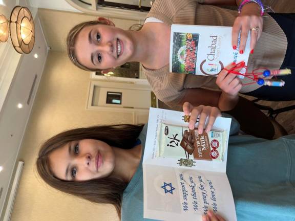 Seventh-grade students from Goshen write letters packaged with sweets to soldiers in the Israel Defense Forces at Chabad Hebrew School with Rabbi Pesach and Chana Burston.