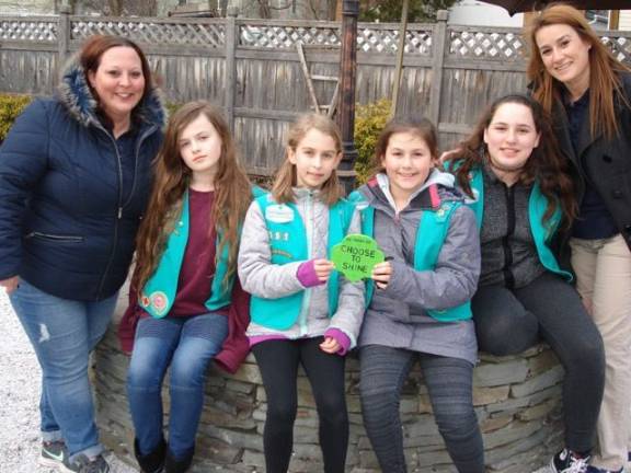 Girl Scouts in Troop 551 show one of their inspirational signs after posting them on the Heritage Trail With them are their leaders, Nicole Petrakis on the left and Rosemarie Rampulla on the far right. The Scouts are (from left): Lucy Attreed, Nera Weinstein, Aubrey Rampulla and Rhiannon Petrakis. The group began their walk on the trail at Trailside Treats Creamery, and afterward they each enjoyed a well-earned ice cream treat. (Photo by Geri Corey)