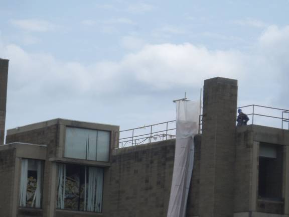 The demolition begins Construction workers were busy on the roof of the Orange County Government Center in Goshen on Thursday as demolition work continues. (Photo by Nathan Mayberg)