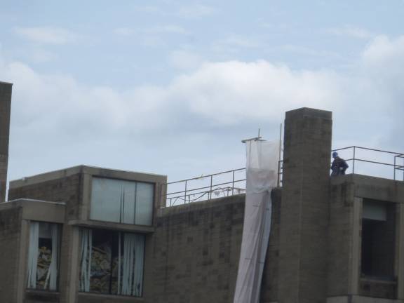 Construction workers were busy on the roof of the Orange County Government Center in Goshen on Thursday as demolition work continues. (Photo by Nathan Mayberg)