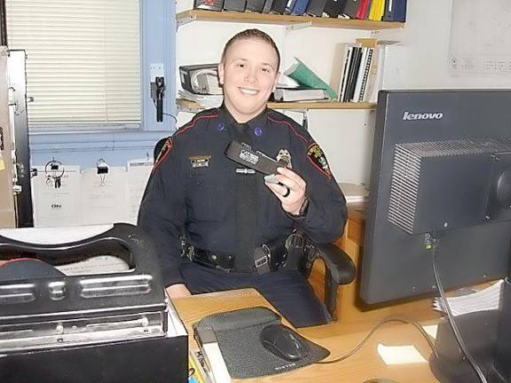 Patrolman Robert Kozlowski with the Village of Goshen Police Department holding the CAT Application Tourniquet that aided in saving the life of a Goshen woman. Officer Kozlowski calls it an invaluable tool in halting uncontrollable bleeding and saving lives.