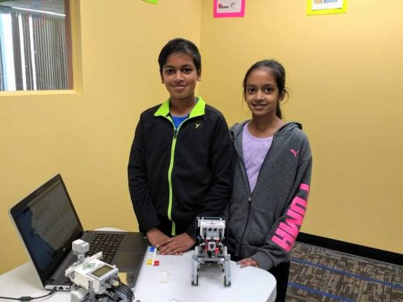 Ashok and Swathi Sathiyamoorthy with their robot Puppy (Photo by Ginny Privitar)