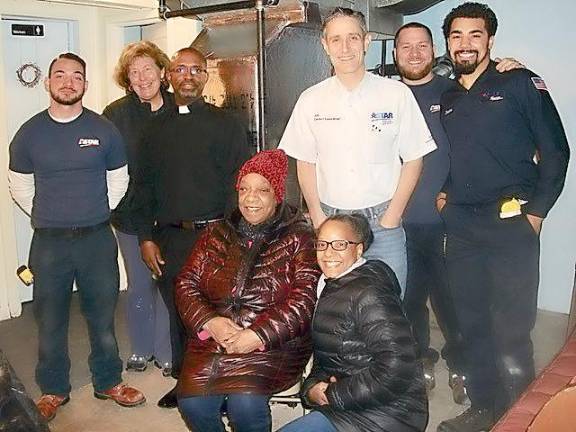 Mary Sumter and her daughter Marcia Terrell, upfront, are happy to get a new furnace for St. John’s AUMP Church. With them, are (from left): Fausto Palumbo, volunteer Diane Dinan, the Rev. Brazley Young, Jeff Abraham, Nick Brown, and Jericho Male. Palumbo, Brown, and Male installed the new furnace, donated by Astar Plumbing, Heating and Air Conditioning.