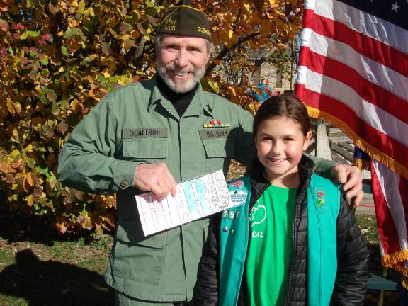A stirring ceremony at Goshen memorial Aubrey Rampulla, a Girl Scout in Troop 551, presented VFW Commander Ray Quattrini with a “Thank you for your service” letter (Photo by Geri Corey)