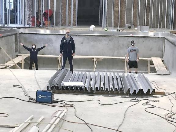 South Orange Family YMCA staff stand in the deepest part of the Y’s new pool, which is planned to open this spring. Provided photos.