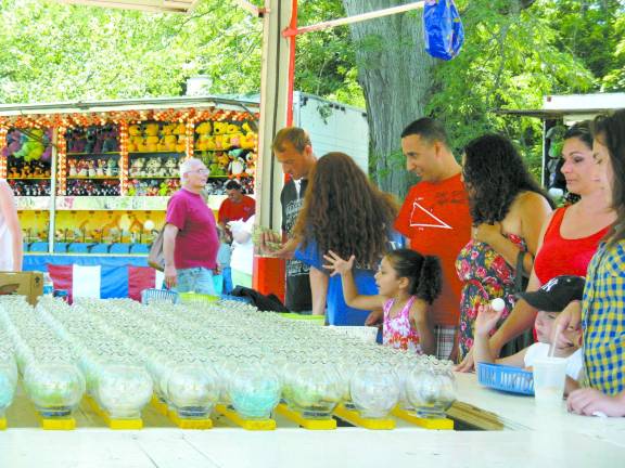Great American Weekend brings on the crowds Trying to earn a goldfish: Will the ball land in the vase?