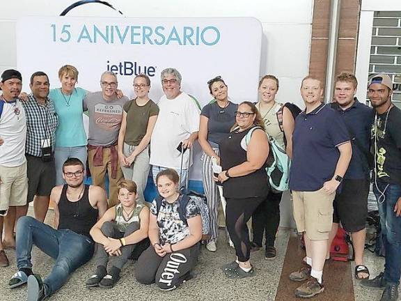 Front row (from left): Charles Phelan, Matt Csernai, Emma Boardman. Back: Hugo Chavez (from Bridges to Community), Mark Glasse, Carol Phelan, Ken Crosby, Shannon Roper, Scott Roper, Carly Glasse, Allison Csernai, Tierney Crone, Robert Boardman, Trent Larson, Louis Gonzales.