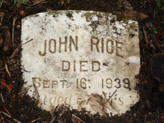 Not all of the markers are like this raised tombstone, which has a name and dates inscribed (Photo by Geri Corey)