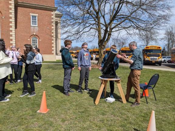 C.J. Hooker Middle School students view the solar eclipse through a telescope with a solar filter.