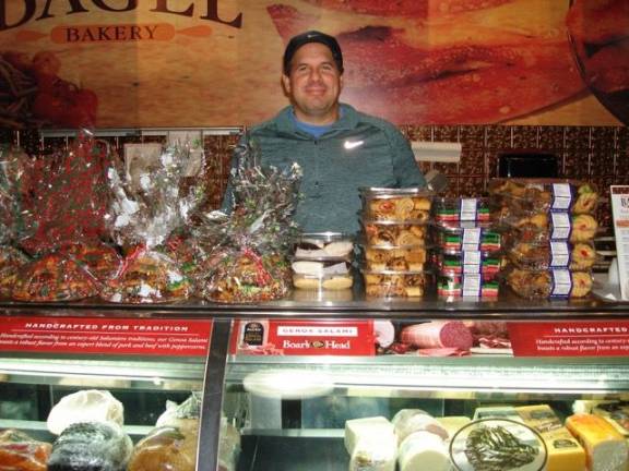 Goshen will get you through the holidays in style Brent Kunis, owner of Orange County Bagel, offers holiday cookies wrapped and ready to bring as a gift. The shop will be open on Christmas Day, 7 a.m. to noon. (Photo by Geri Corey)