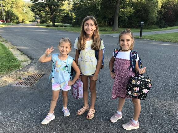 Smiling through the first day of school Chloe, Nora and Jane gear up for second, fifth and fourth grade.