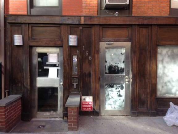Landlord sued for running illegal hotel 156 West 15th Street, which officials say was being operated as an illicit hotel through Airbnb listings, is now entirely vacant, and court and other notices are plastered throughout its hallway entrance. Photo: Clarrie Feinstein