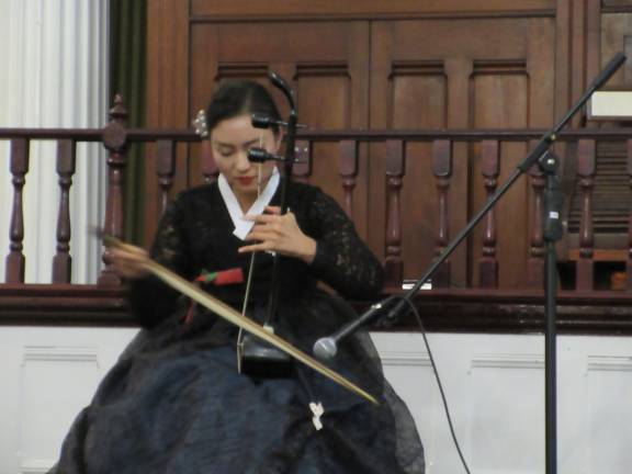Korean Cultural Night dazzles the community Leekyung Kang plays the haeguem (Photo by Ginny Privitar)