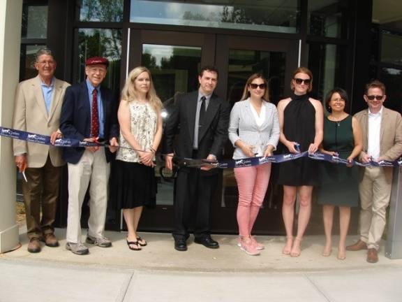 Goshen's 'miracle' library celebrates grand opening Bernard Marone (center), president of the board of trustees of the Goshen Public Library and Historical Society, is prepared to cut the ribbon. He’s flanked by board and committee members, with library director Matthew Gomm on the far right. (Photo by Geri Corey)