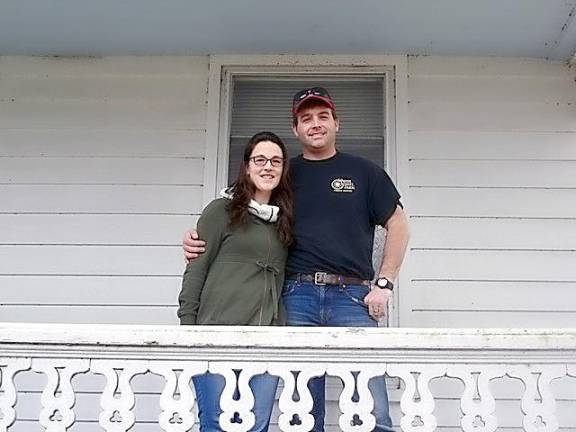 Kristen and Jason Touw happily pose on the porch of the “big house” located on Wagon Wheel Farm, Sarah Wells Trail, in Goshen. After long negotiations with inheritors of the property, the Touw offer to purchase was finally accepted.