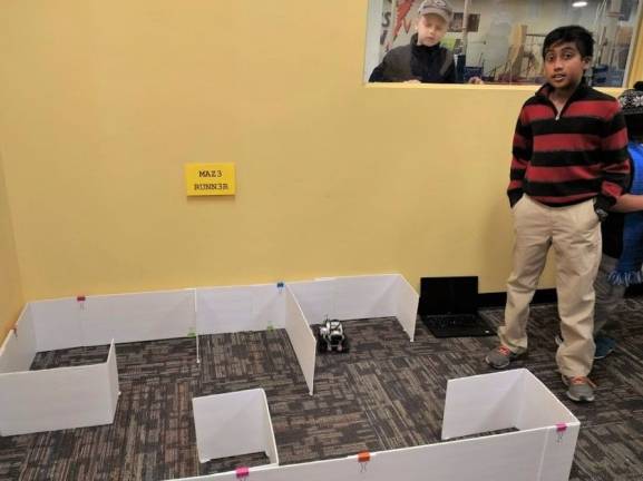Pravin Jegan with his maze-running robot (Photo by Ginny Privitar)