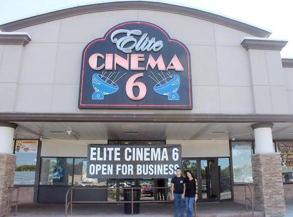 An iconic sign is lit up once more Dianne Kopac, pictured here with her son, reopened the Elite Cinema 6 movie theatre on Friday, Sept. 3, after a year and a half of closure due to the COVID-19 pandemic. Photos by Hanna Wickes.