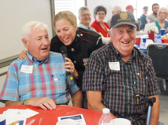 On Sunday, Sept. 29, Master Sgt. Mary Kay Messenger of the West Point Band sang at the meet and greet for the upcoming Honor Flight veterans and their escorts held at the Walden Fire Department. She is pictured here singing to brothers John White, left, of Dutchess County, and Bernard White, an officer of the American Legion in Greenwood Lake. The 24th Honor Flight mission to Washington, D.C., is scheduled for Oct. 12. There are 83 veterans going on the upcoming flight: ten from World War II, 37 from the Korean War, 20 from Cold War and 16 from Vietnam. Six men from Greenwood Lake are among the deployment.