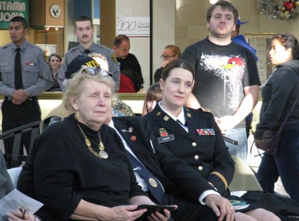 70 years ago, in a dark and snowy wood Seated, Eileen Pileggi and M.Sgt. Mary Kaye Messenger of West Point, who sang the National Anthem. (Photo by Ginny Privitar)