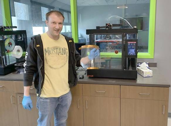 Goshen High School Technology Teacher Joe Fedor designed the protective mask that are being manufactured using the high schools 3-D printers and laser cutters.