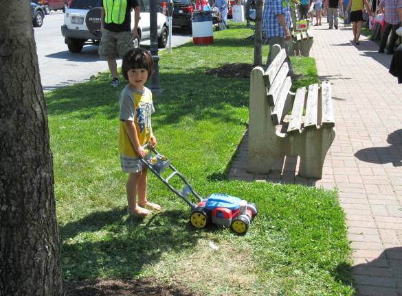 Scenes from Great American Weekend Naito Gerringer of Forestburgh passes the time by cutting the grass.