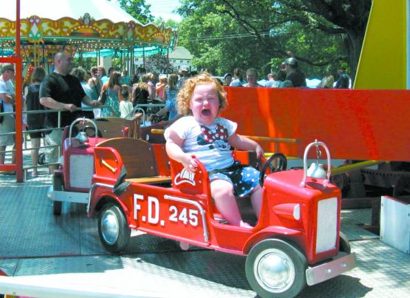 Great American Weekend brings on the crowds This little lady wants off! She found the fire truck ride more frightening than fun.
