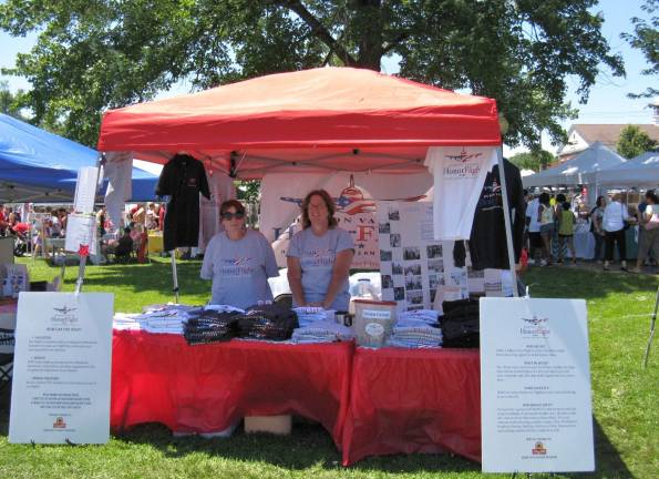 Great American Weekend brings on the crowds Amy Prado and Mary Lewis of Walden give out information at the Honor Flight tent. Honor Flights are free to veterans. They take World War II veterans on a one-day flight to Washington, D.C., to see the World War II memorials.