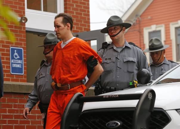DA charges Frein with terrorism Eric Frein is escorted by police into the Pike County Courthouse for his arraignment in Milford, Pa., Friday Oct. 31, 2014. Frein, was captured seven weeks after police say he killed a Pennsylvania State trooper in an ambush outside a barracks in northeastern Pennsylvania. (AP Photo/Rich Schultz)
