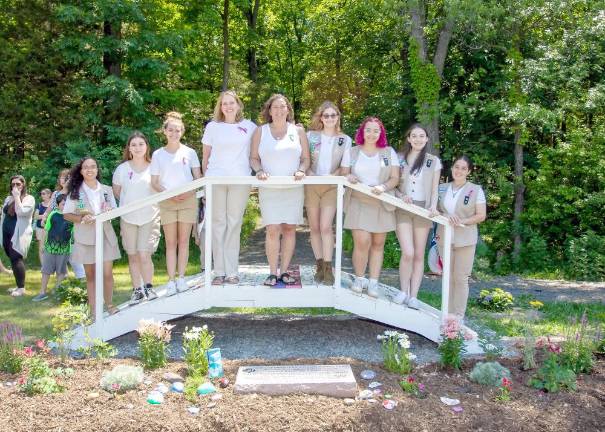 Scout leaders Denise Candela and Cynthia Acevedo are flanked by Girl Scouts from Troop 413.