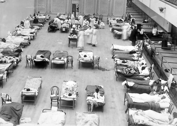 Then and now American Red Cross nurses tend to flu patients in temporary wards set up inside Oakland Municipal Auditorium, 1918