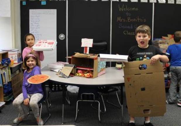 Cardboard challenge in Chester Riley McGuire, seated, made a pizza along with Valeria Gonzalez and Logan DeCastro. (Photos by Ginny Privitar)