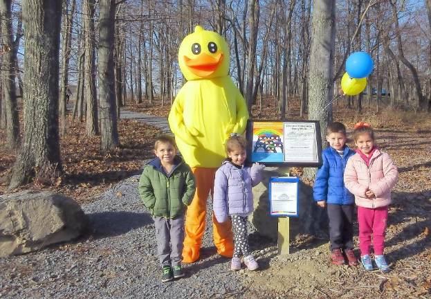 Calvin Tower, 4, Adriana Gennaro, 4, Matthew Gennaro and his twin sister, Angela Gennaro, 5, pose by the first station with the library's mascot Webster the duck