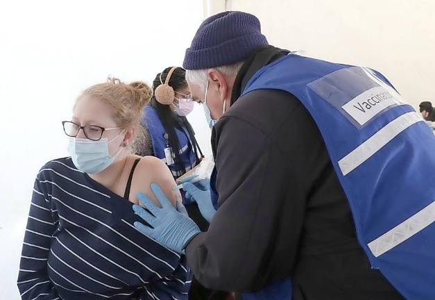 Randy Morse, a Registered Nurse with the Orange County Medical Reserve Corps, administers a vaccine to Elizabeth Black of the City of Newburgh, a preschool teacher. Photo provided by Orange County.