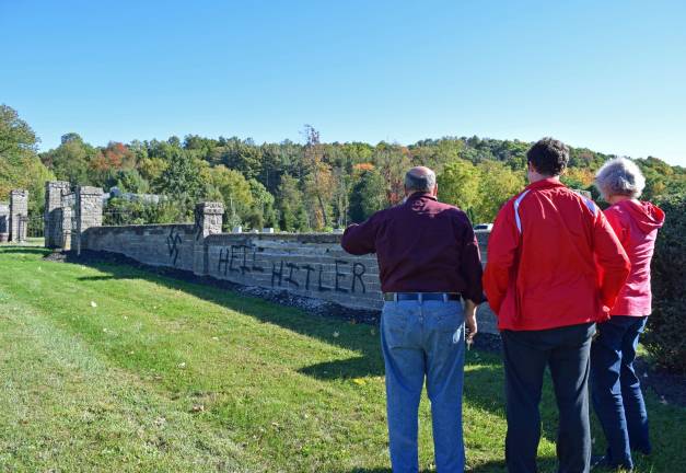 Jewish cemetery desecrated with anti-Semitic graffiti days before Yom Kippur Warwick high schooler Micah Sander visits the vandalized Temple Beth Shalom cemetery with his parents.