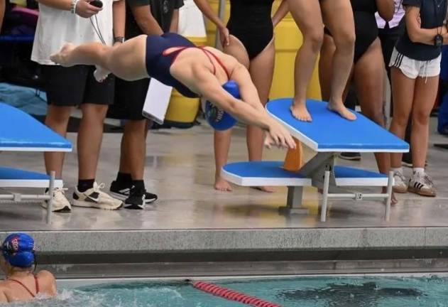 Swim team finish regular season with wins Grace Matthews enters the water during a recent meet.