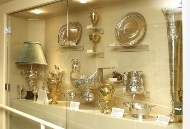 The display case at Harness Racing Museum before and after being burglarized.