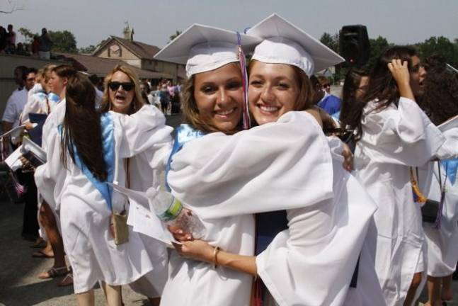 Goshen High School: 'Today as we climb' Best friends hug on the final day their 12-year journey.(Photo by Jerry Goldberg)