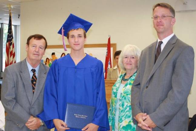 Graduate Sean Ryan with Superintendent Daniel Connor, Board President Judith Green and Principal Kurtis Kotes.