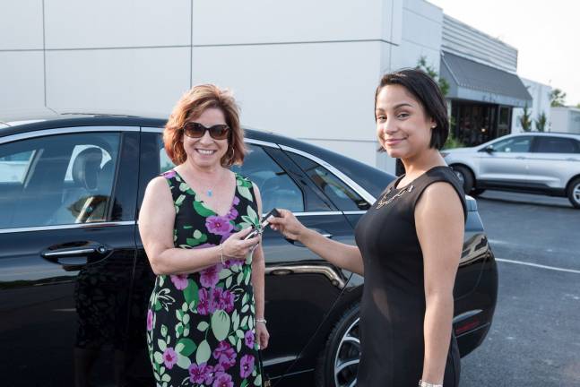 Healey Lincoln's new approach to marketing Claudia Jacobs of Goshen accepts the keys to the first Lincoln she will be driving from Shay Ramirez of Healey Lincoln.