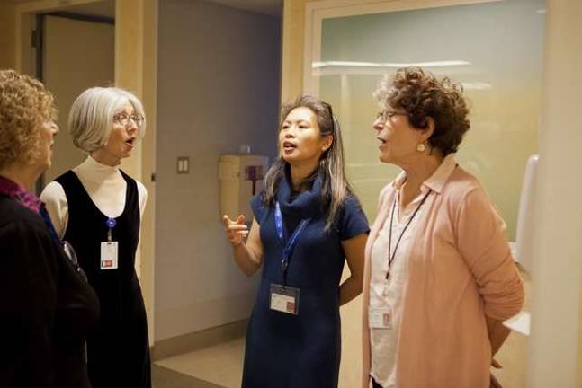 Music Helps Hospice Patients Choir members warm up in the hallways of the hospital, careful to keep their voices low.
