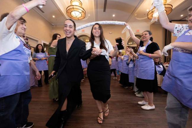 The late Raz Mizrahi (left) celebrates on the dance floor along with fellow Israel Defense Force Soldier Eliya Hrubi (right) and over 150 women and teens at Chabad of Orange County’s Mega Challah Bake at Chabad of Orange County last month in Monroe. Mizrahi was recently killed in a Hamas attack.