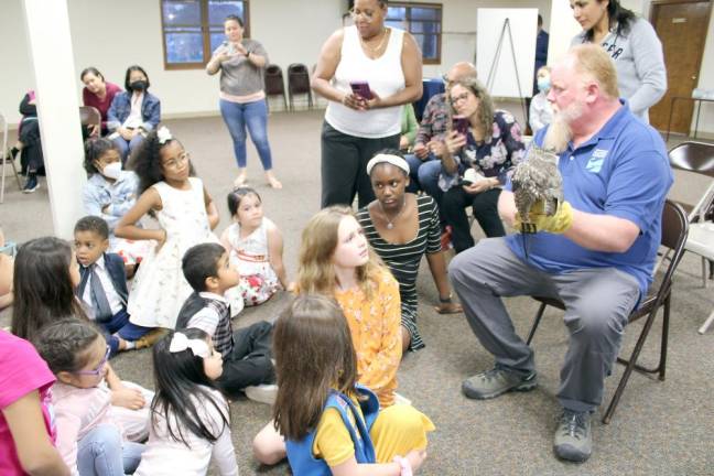 Carl Heitmuller, Director of Programs for Hudson Highlands Nature Museum shows off his owl, Kevin, to Summer Reading &amp; Exercise Challenge participants.