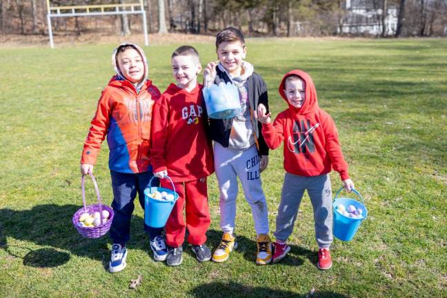 (L-R) Alex Compres, Timothy Scagnelli, Emery Vitez, and George Scagnelli from Chester with their egg filled baskets at the PBA annual Easter Egg Hunt at Chester Commons Park. Photo by Sammie Finch