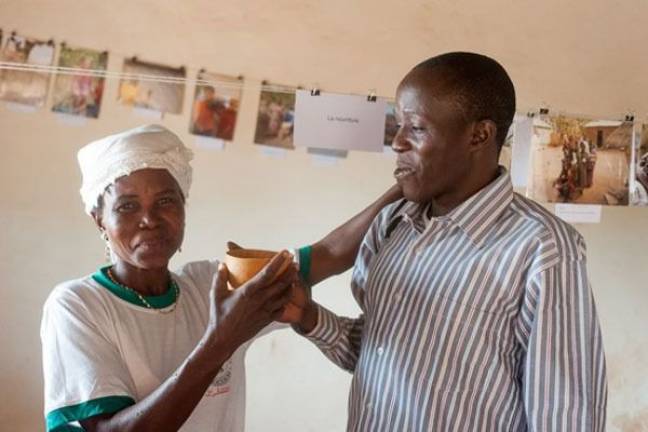 Grant benefits French class's pen pal project Mr. Frouti, a local teacher and liaison in Benin, Africa, celebrates the exhibit with a local parent. Part of the exhibit displayed pictures of foods and drinks in France, Benin, and the U.S.