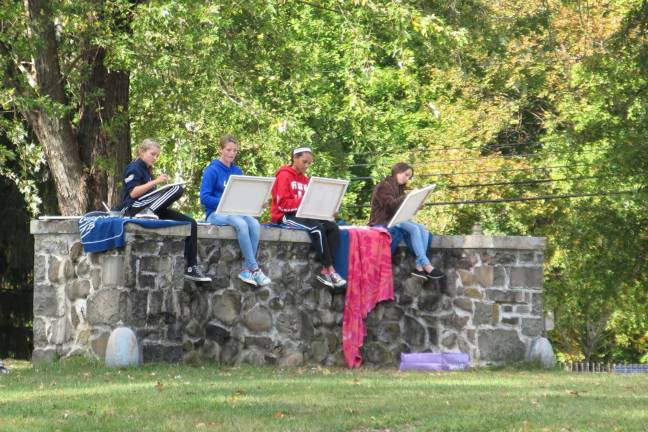 Creativity under an open sky Jillien Gerace, Alexa Stack, Kenda Ramberan and Skyler Stiskin concentrate on their artwork.