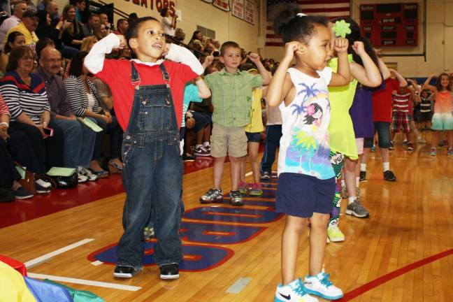Smiles, giggles at Kindergarten Festival Isiah Vega and Loreal Campbell show off their muscles!