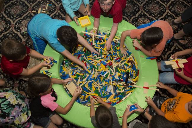 Photo by Robert Breese Children play in a big tub of Legos at Merlin Entertainment's open house event in Goshen last summer.